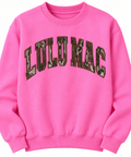 Clean studio product photo of bright pink Lulu Mac youth sweatshirt with Mossy Oak camouflage lettering